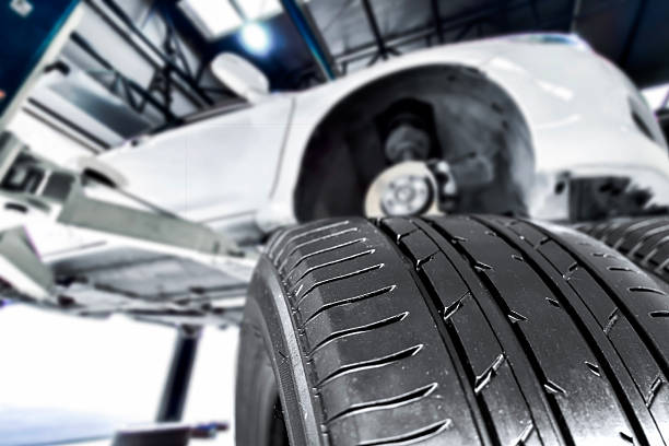 istock New tire treads ready for installation under a car on a lift 2247395651