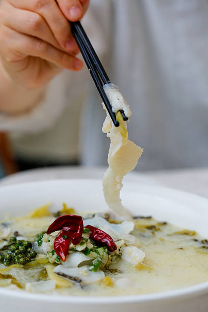istock Lifting a piece of fish from spicy sour cabbage soup with chopsticks 2247396907