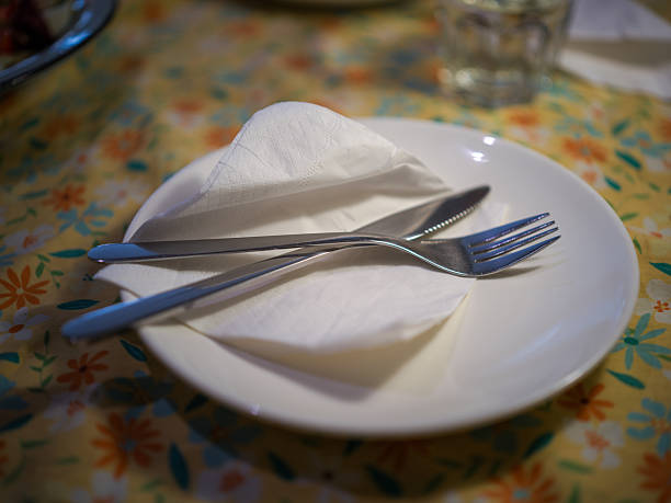 istock A Neatly Arranged Table Setting with Cutlery and Napkin on a Floral Tablecloth 2247397111