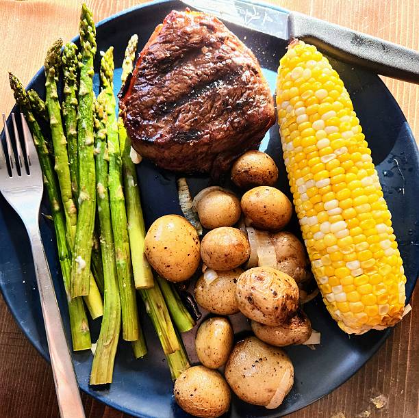 istock Grilled Steak Dinner with Asparagus, Corn, and Roasted Potatoes 2247400875