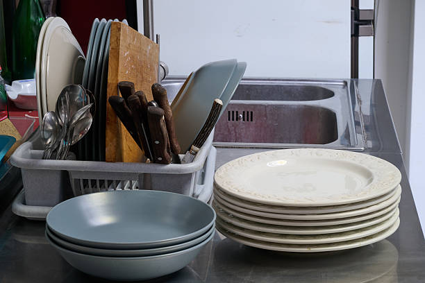 istock filled dish dryer and plates on counter 2247403205