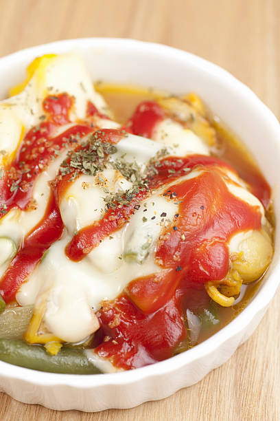 Vegetable dish topped with cheese and tomato ketchup