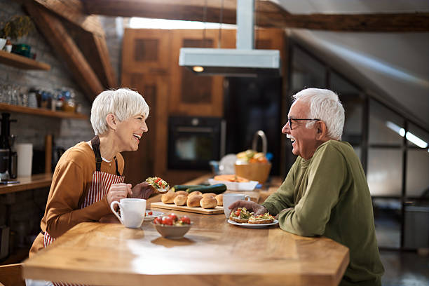 istock Happy senior couple talking during breakfast in dining room. 2247405687