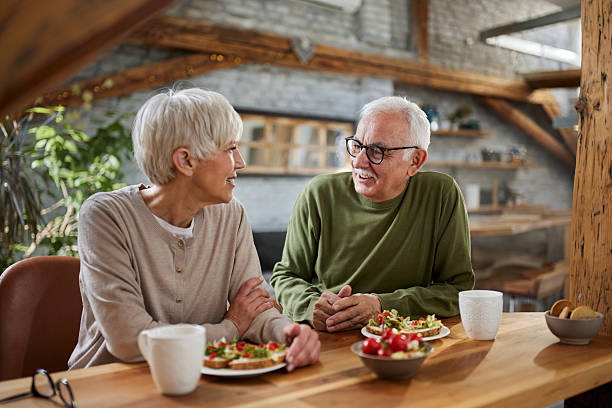 istock Happy mature couple talking during breakfast time in dining room. 2247405842