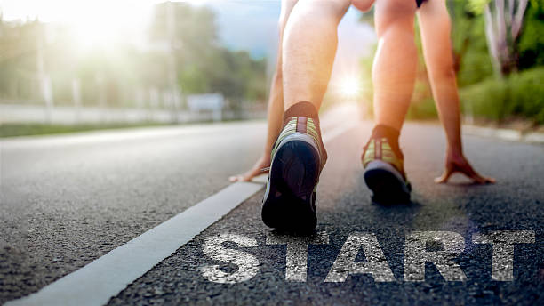 istock A runner in starting position on an outdoor road with strong sunlight, symbolizing motivation, determination, and the beginning of a new journey. Ideal for concepts of start, goal setting, fitness, and success. 2247406451