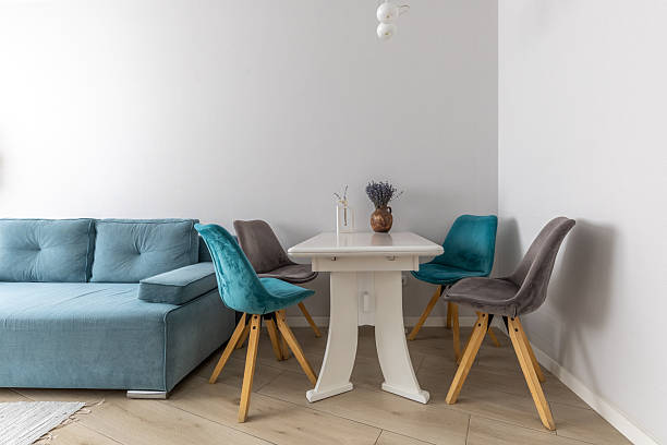 istock Cozy Dining Corner with Velvet Chairs and Blue Sofa 2247406484