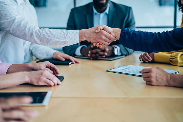 istock Businesspeople shaking hands across the table. 2247406526