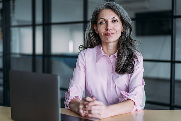 istock Successful businesswoman in modern office working on laptop. 2247406558