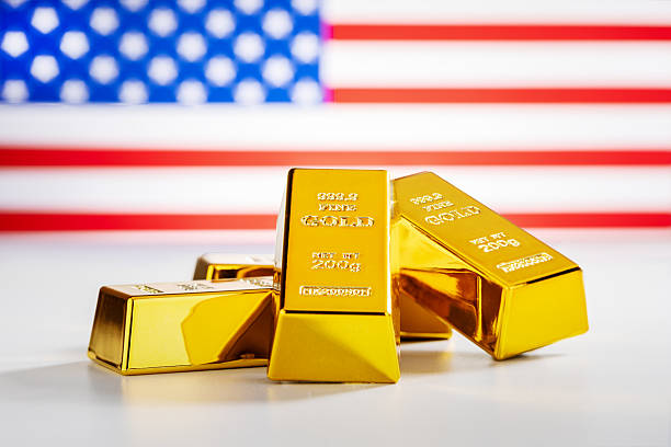 istock Golden ingots and USA flag on the background. 2247407278