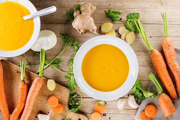 istock vegetable soup in bowl with ingredients on wooden board, top view 2247408047