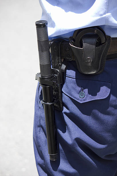 istock Police officer holding handcuffs 2247408243