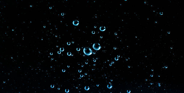 istock Floating blue water bubbles on a dark background, ideal for skincare hydration visuals, cosmetic serum concepts, moisture advertising, clean beauty themes, and scientific product design. 2247409823