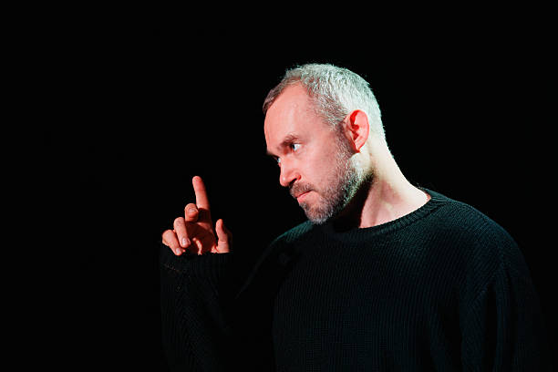 istock Serious performer gesturing and looking away on theater scene 2247411813