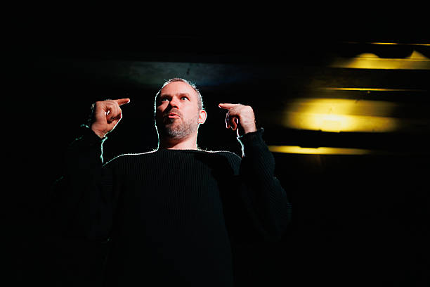 Mid adult man singing at recording studio