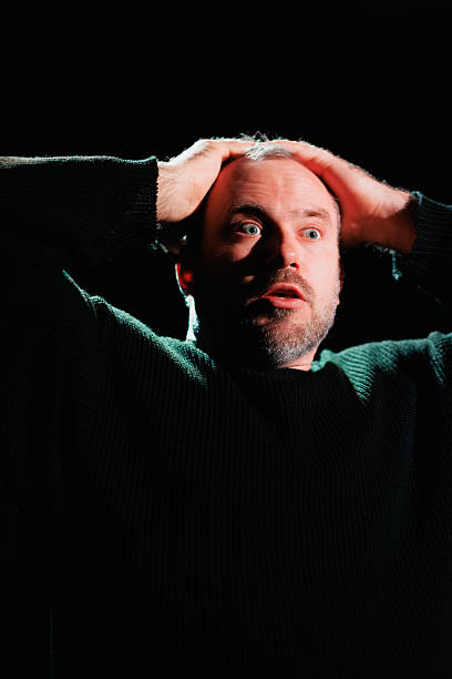 istock Shocked actor performing role on scene with black background 2247413447