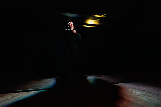 istock Professional actor playing role on stage with lighting and shadow 2247413509