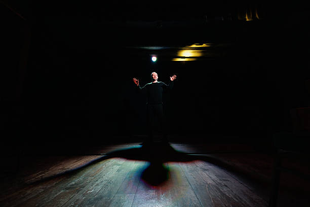 Actor performing on theater scene with lighting