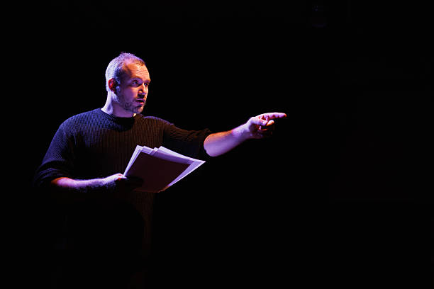 istock Actor rehearsing with scenario and pointing away on theater scene 2247413784
