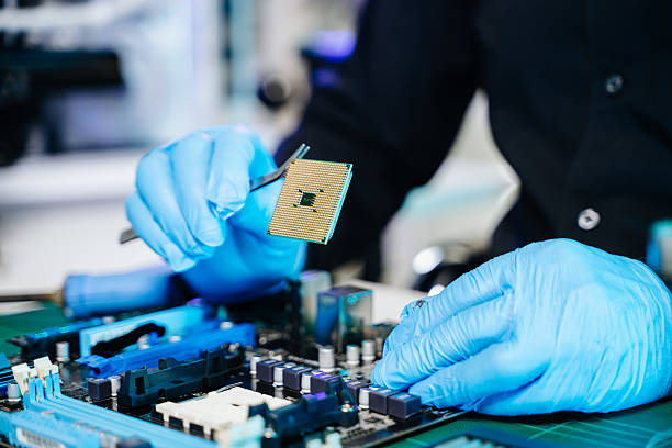 istock The technician is putting the CPU on the socket of the computer motherboard. electronic engineering electronic repair, electronics measuring and testing, repair 2247413877