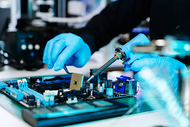 istock Closeup of technician soldering a computer motherboard with precision tools, showcasing electronics repair, hardware technology, and innovation 2247413879