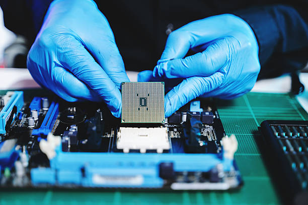istock The technician is putting the CPU on the socket of the computer motherboard. electronic engineering electronic repair, electronics measuring and testing, repair 2247413883