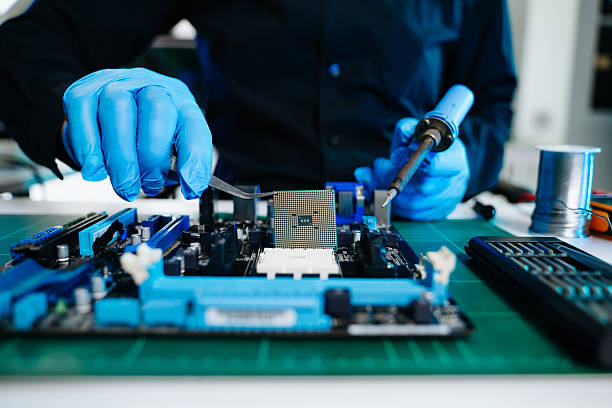 istock The technician is putting the CPU on the socket of the computer motherboard. electronic engineering electronic repair, electronics measuring and testing, repair 2247413897