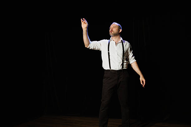 istock Actor in elegant outfit performing on stage 2247414732