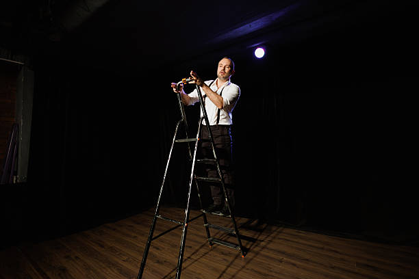 Full-length of emotional bearded bald man, in classical suit playing violin against gradient purple background in neon light. Concept of music, talent show, performance, concert, festival, instruments