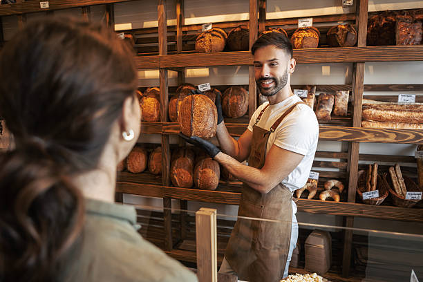 istock Male Pastry Chef Displaying Fresh Bake in Store 2247418156