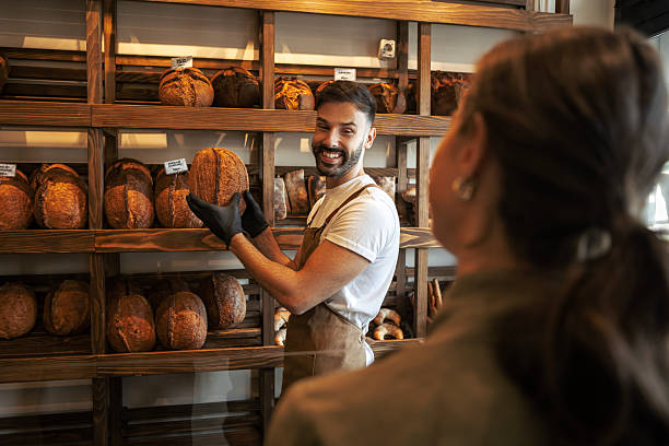 istock Baker Showcasing Handmade Pastry to Customers 2247418266