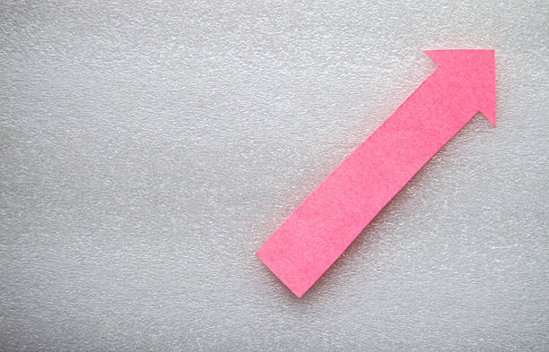 One big large up arrow shape paper cutting placed over textured gray white surface background leaving copy space for growth,  success, moving up profits, direction sign banner poster presentation.