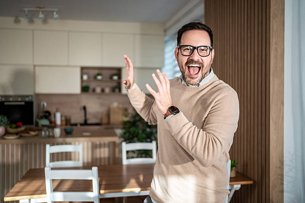 istock Excited man gesturing a big surprise in kitchen 2247420486