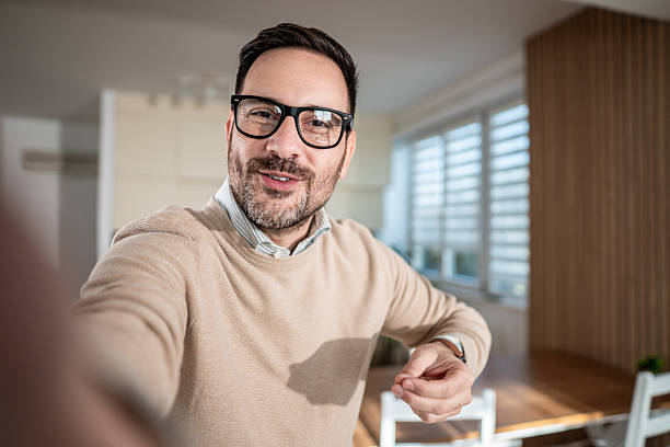 istock Man smiling during video call from home 2247420648