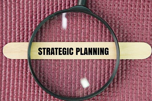 istock Magnifying glass and stick with the word Strategic planning. 2247421127