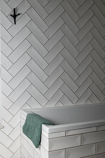 istock green towel in a modern white tiled bathroom with a bath 2247424003