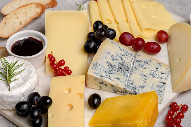 istock gourmet cheese platter with craft cheese assortment on a marble platter. hard cheeses, mold cheese, gorgonzola, pecorino, Emmental, Roquefort cheddar 2247425745