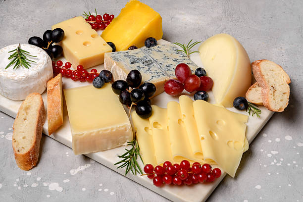 istock gourmet cheese platter with craft cheese assortment on a marble platter. hard cheeses, mold cheese, gorgonzola, pecorino, Emmental, Roquefort cheddar 2247425778