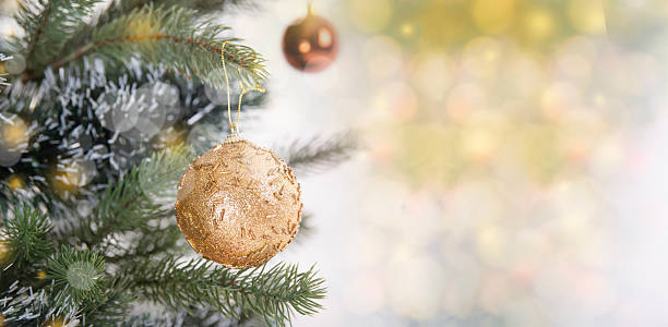 istock Christmas tree decoration with colorful ornaments on green branches creating a festive holiday atmosphere and warm seasonal celebration backdrop with soft golden bokeh 2247428005