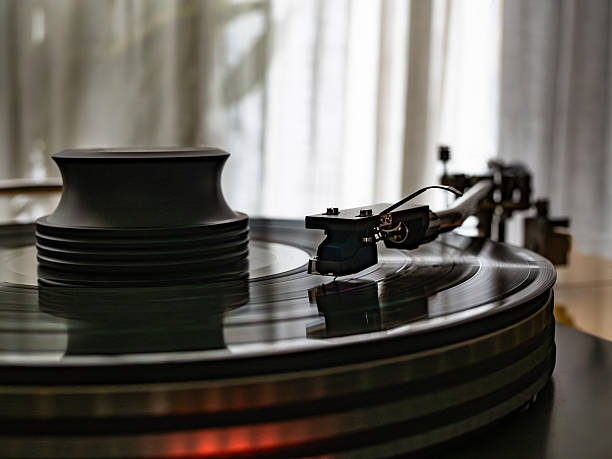 istock Vinyl record spins on a turntable playing music 2247428573