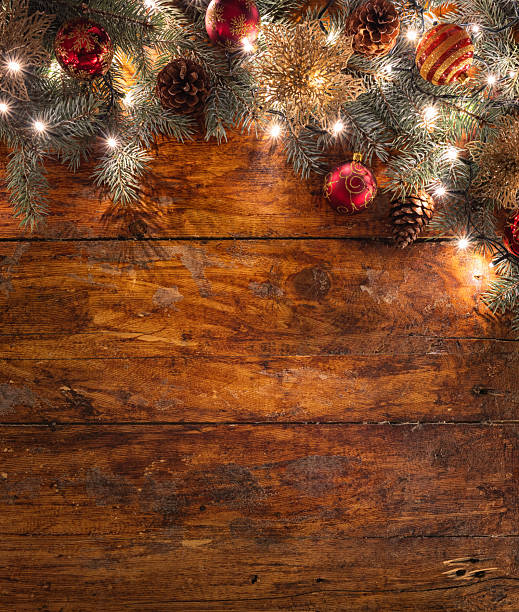 istock A festive Christmas garland with red ornaments on a rustic wooden backdrop 2247429036