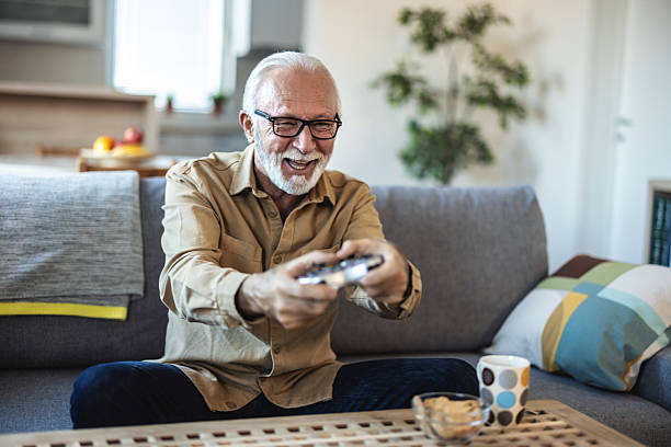 istock Senior, man and gaming with console controller for video games or online entertainment in home. Elderly, male person or gamer with joystick on couch for esport subscription or competition. 2247430086