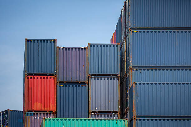 istock Stacked Shipping Containers at a Port Terminal Under Clear Sky 2247430692