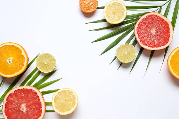 istock Bright fruit background. Colorful fresh fruit on a white table. Orange, lime, lemon, grapefruit. Flat lay, top view, copy space. 2247431167