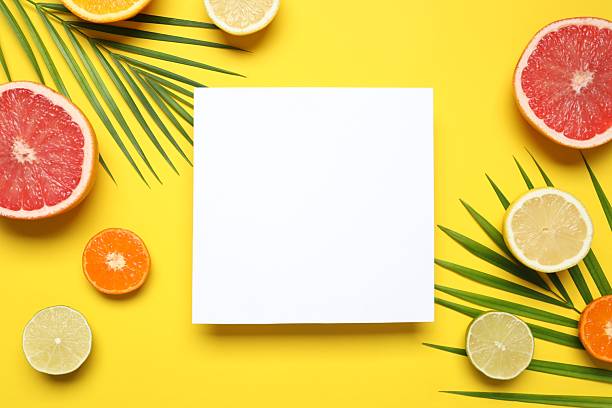 istock Flat lay with white paper card and fruits on yellow background. Space for text 2247431296