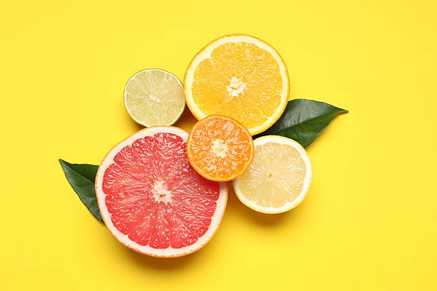 istock Yellow paper background with citrus fruits 2247431333