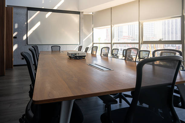 istock Modern Conference Room Interior with Large Wooden Table and Floor-to-Ceiling Windows 2247432448