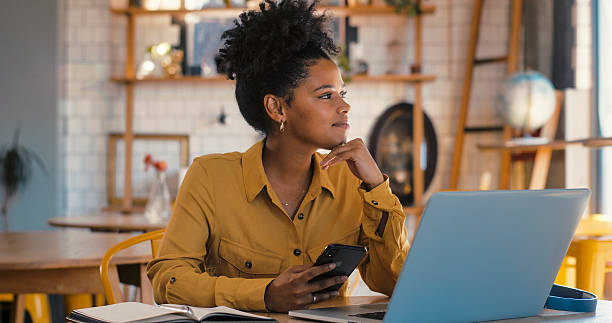 istock Young woman concentrates while using laptop in coffee shop. 2247432879