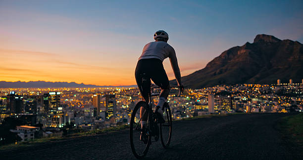 istock Mountain and man cycling on road with sunrise. 2247433777
