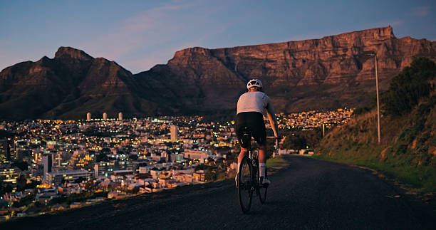 istock Mountain and man cycling on road with sunrise. 2247433805