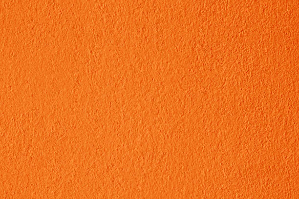 Orange wall background with light and shadow.